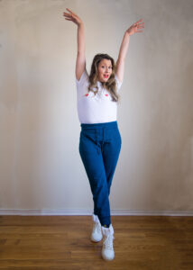 miss al boogie poses with arms in the air and legs crossed